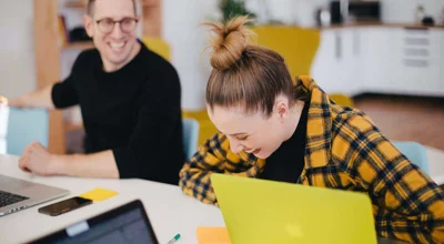 Man laughing looking at a girl who is bend over laughing  Man laughing looking at a girl who is bend over laughing